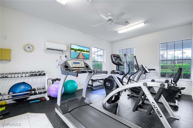 exercise room featuring a wall mounted air conditioner and ceiling fan