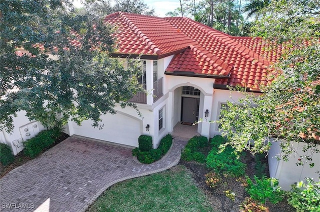 2451 Game Hawk Ct Unit 2502, Naples, FL 34105 - view of front of property featuring a tiled roof, a garage, stucco siding, and decorative driveway