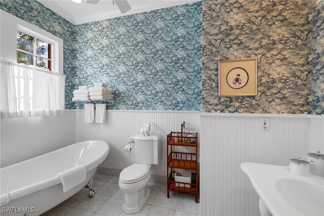 bathroom with sink, toilet, crown molding, a washtub, and ceiling fan