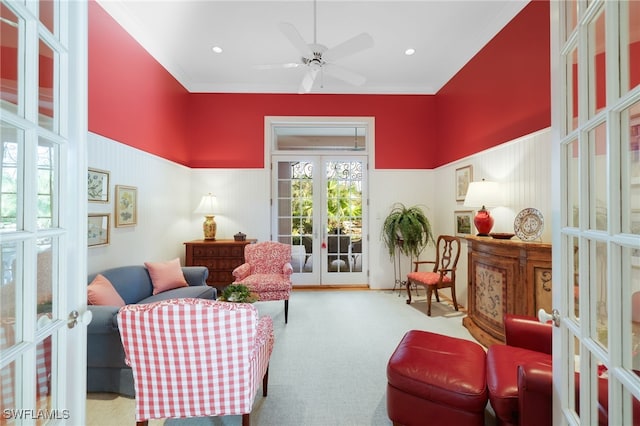 sitting room with ornamental molding, ceiling fan, light colored carpet, and french doors