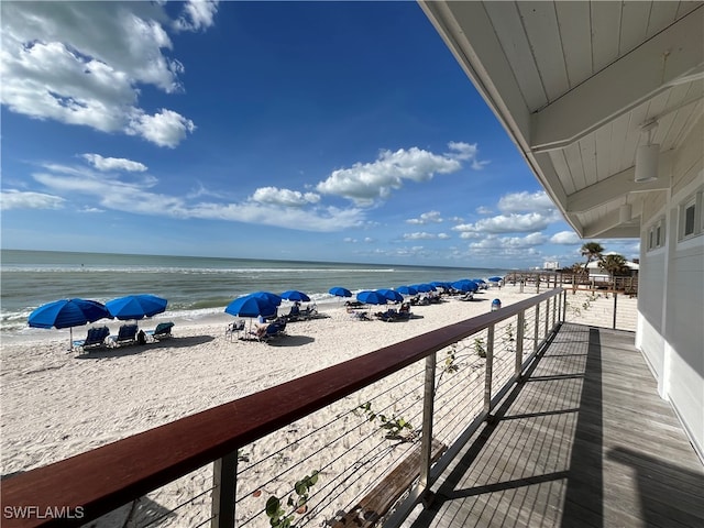 balcony with a beach view and a water view