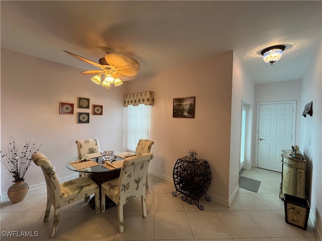 tiled dining room featuring ceiling fan