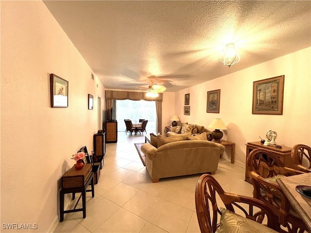 871 Tanbark Dr Unit 101, Naples, FL 34108 - living area with light tile patterned flooring, a textured ceiling, and ceiling fan