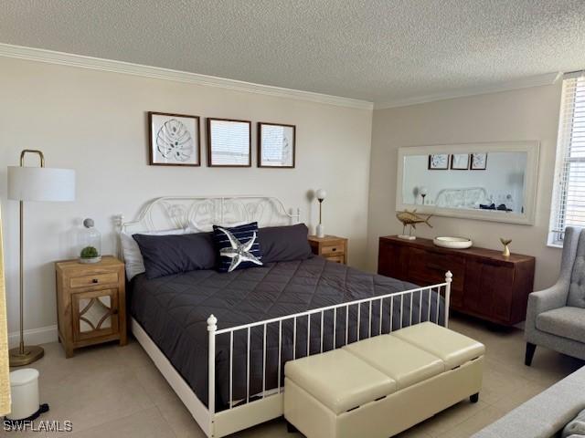 bedroom with ornamental molding and a textured ceiling