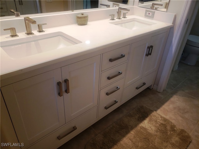 bathroom featuring tile patterned floors, vanity, and toilet