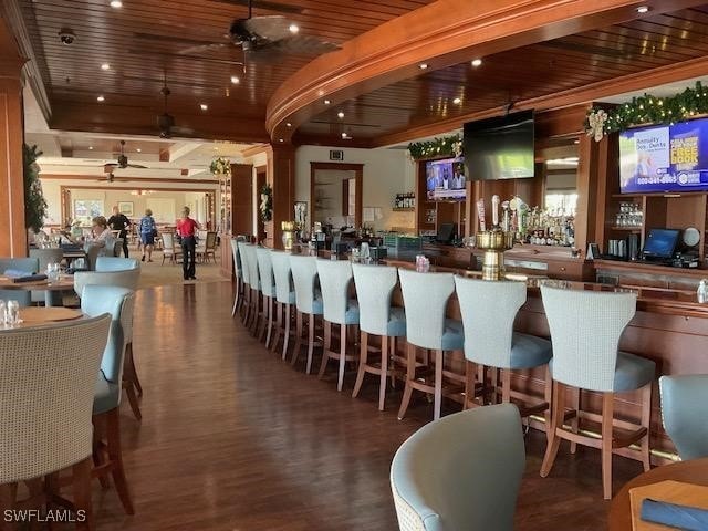 bar with hardwood / wood-style flooring, ceiling fan, and wood ceiling