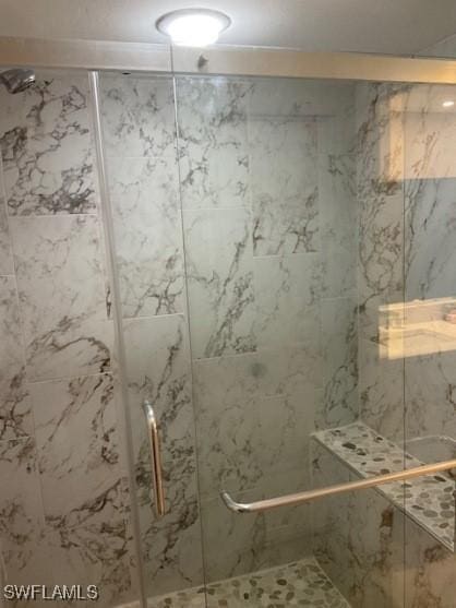 bathroom with a shower with shower door