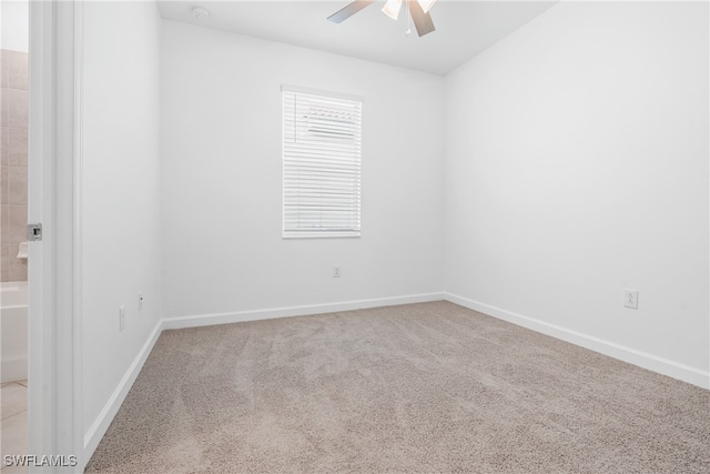 carpeted spare room with ceiling fan