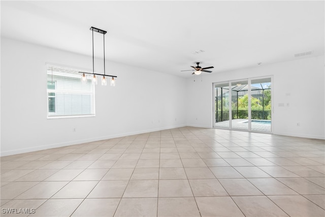 unfurnished room with light tile patterned floors and ceiling fan