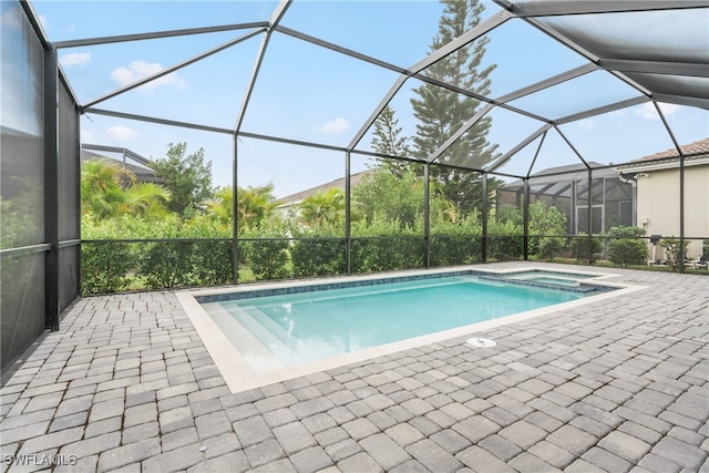 view of swimming pool with a lanai and a patio