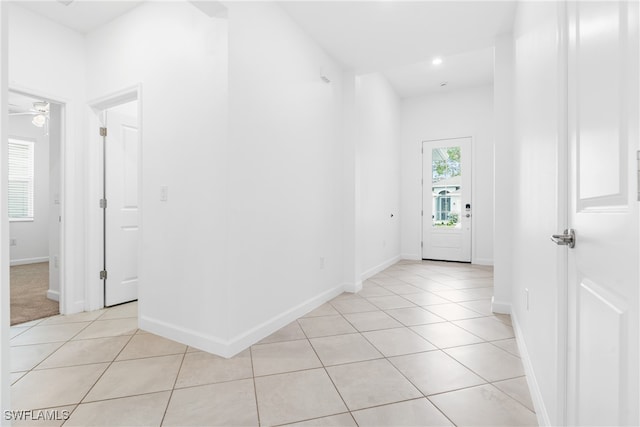 hall featuring light tile patterned floors