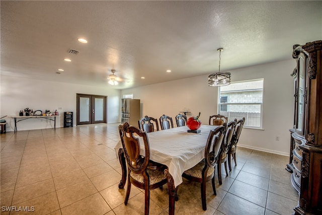 dining area with light tile patterned flooring, ceiling fan, and french doors