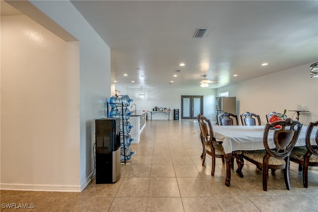 dining space featuring french doors, ceiling fan, and light tile patterned floors