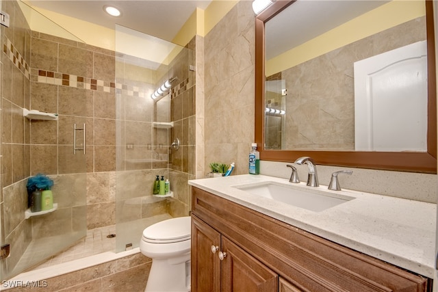 bathroom with vanity, toilet, and an enclosed shower