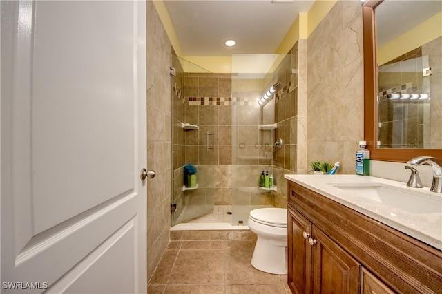 bathroom with walk in shower, vanity, toilet, and tile patterned floors