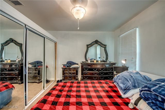 carpeted bedroom with a closet