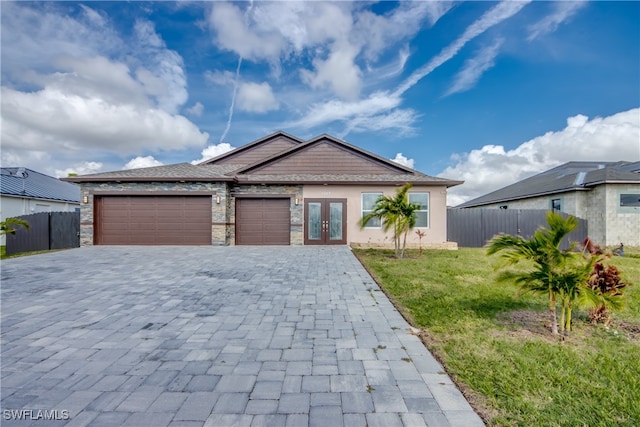 view of front of home with a front lawn and a garage