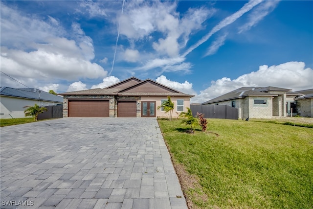 view of front of house with a garage and a front yard