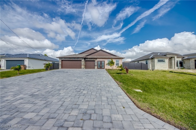 view of front of house featuring a front lawn and a garage