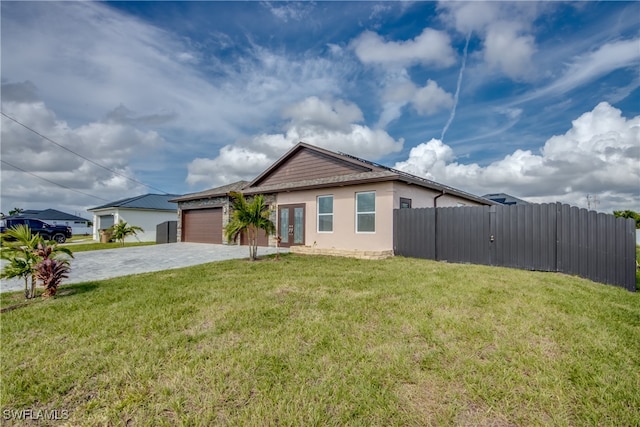 view of front of home featuring a garage and a front yard