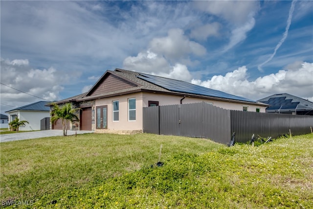 view of home's exterior featuring a garage and a yard