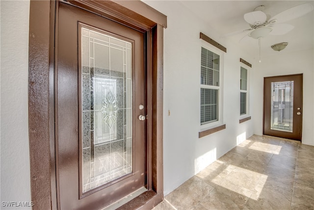 property entrance with ceiling fan