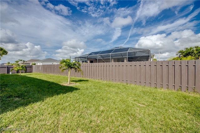 view of yard featuring glass enclosure