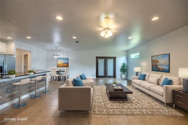 living room with french doors and light tile patterned floors