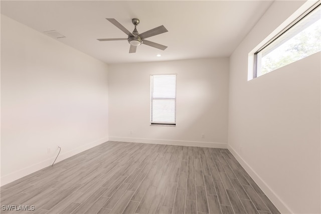 spare room with ceiling fan and light wood-type flooring