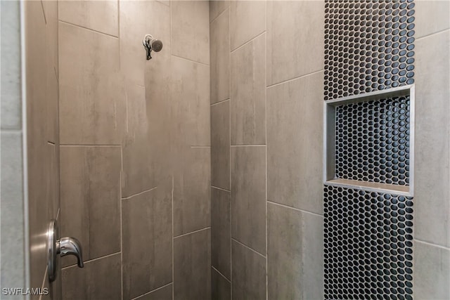 interior details with a tile shower