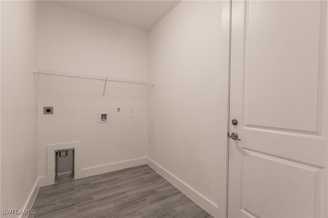 laundry area with hookup for an electric dryer, hookup for a gas dryer, wood-type flooring, and washer hookup