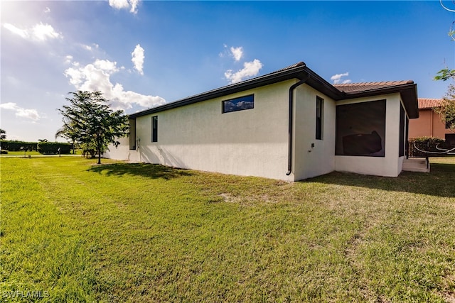 view of home's exterior featuring a yard