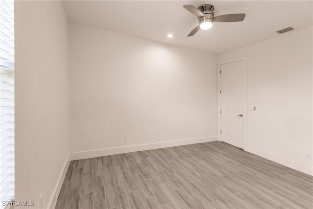 empty room with ceiling fan and light hardwood / wood-style floors