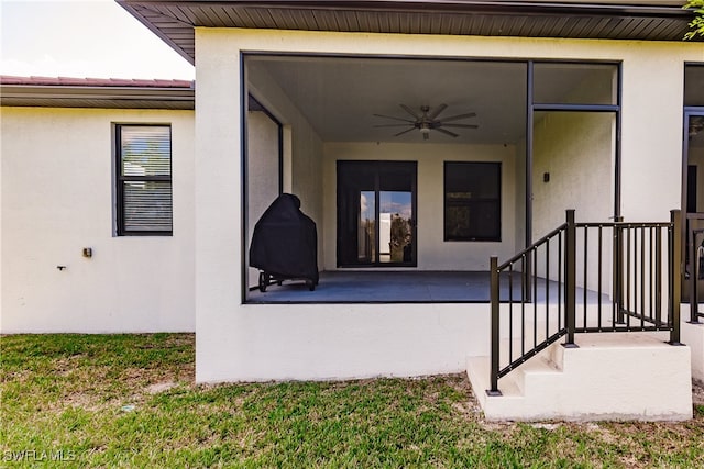 property entrance featuring ceiling fan and a patio