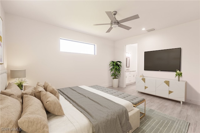 bedroom with hardwood / wood-style floors, connected bathroom, and ceiling fan