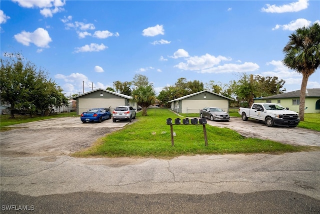 single story home featuring a garage and a front lawn