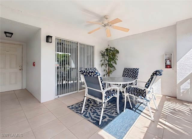 tiled dining room featuring ceiling fan