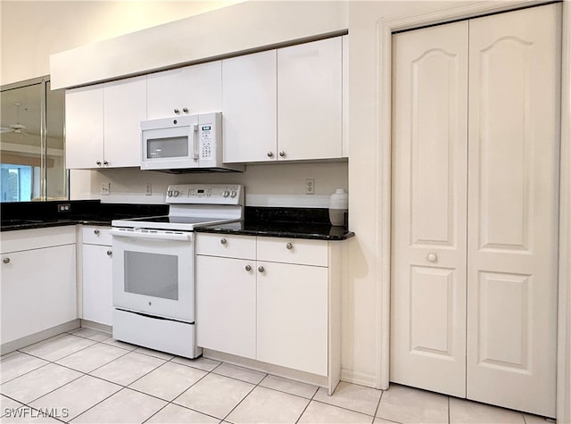 kitchen featuring white cabinets, light tile patterned floors, and white appliances