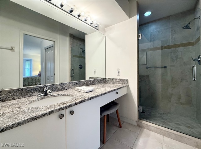 bathroom with vanity, tile patterned floors, and a shower with shower door