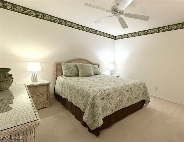 bedroom with ceiling fan and light colored carpet