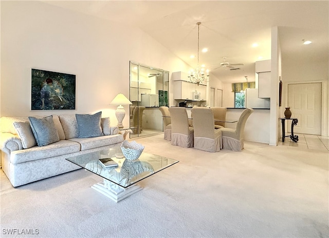 living room with light colored carpet, ceiling fan with notable chandelier, and high vaulted ceiling