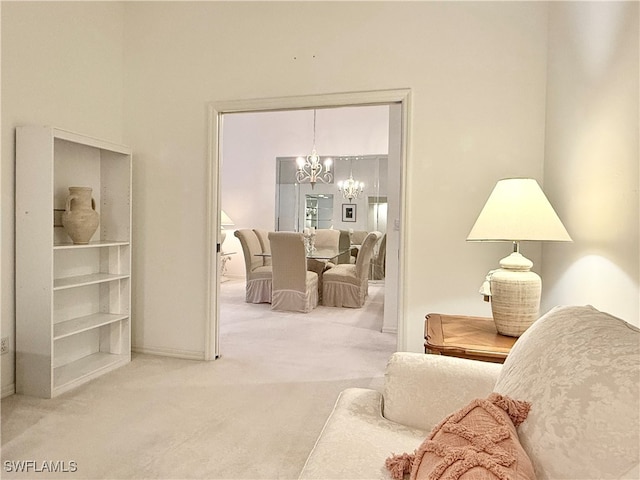 living room featuring a chandelier and carpet floors