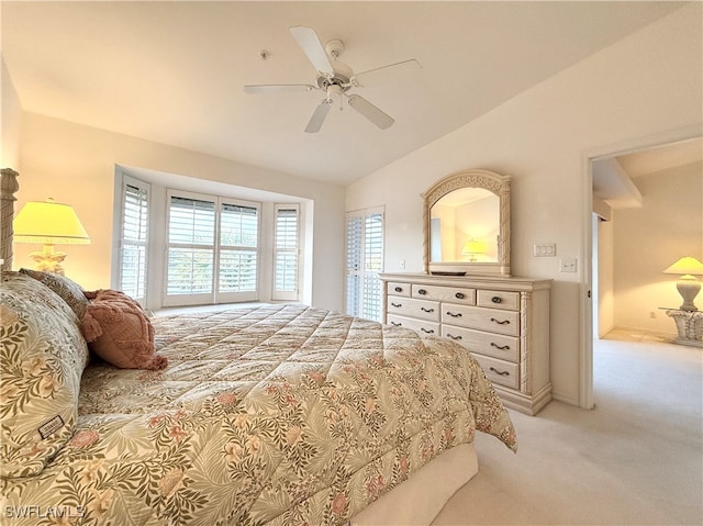 bedroom with ceiling fan, multiple windows, vaulted ceiling, and light colored carpet