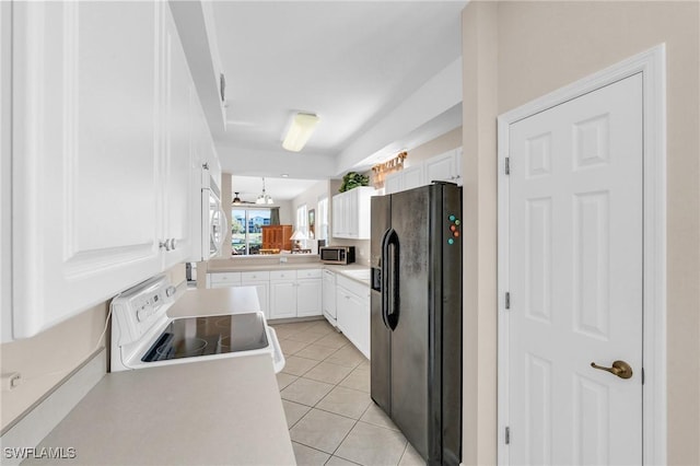 3970 Loblolly Bay Dr Unit 5-108, Naples, FL 34114 - kitchen featuring white appliances, white cabinetry, light tile patterned floors, light countertops, and a peninsula