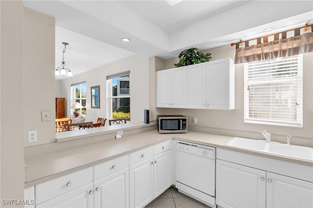 3970 Loblolly Bay Dr Unit 5-108, Naples, FL 34114 - kitchen featuring dishwasher, stainless steel microwave, a sink, a chandelier, and light countertops