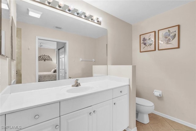 3970 Loblolly Bay Dr Unit 5-108, Naples, FL 34114 - bathroom with ensuite bathroom, toilet, vanity, tile patterned floors, and baseboards