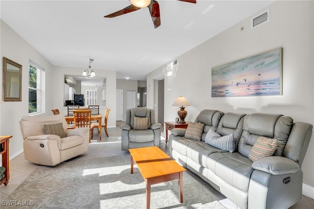 3970 Loblolly Bay Dr Unit 5-108, Naples, FL 34114 - living room featuring ceiling fan, light tile patterned flooring, baseboards, and a chandelier