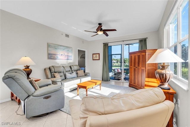 3970 Loblolly Bay Dr Unit 5-108, Naples, FL 34114 - living area with plenty of natural light, ceiling fan, baseboards, and light tile patterned floors