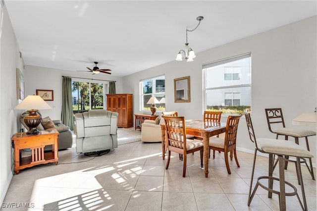 3970 Loblolly Bay Dr Unit 5-108, Naples, FL 34114 - dining space with light tile patterned floors, ceiling fan, and a chandelier