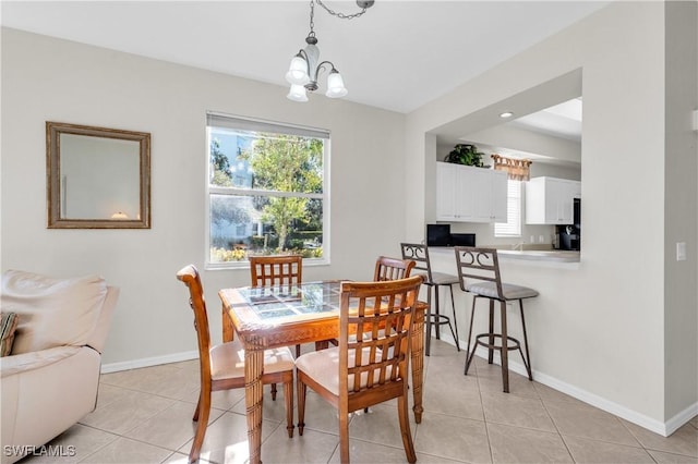 3970 Loblolly Bay Dr Unit 5-108, Naples, FL 34114 - dining space with a chandelier, baseboards, and light tile patterned floors